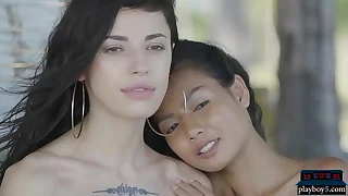 Petite Asian and Russian teen lesbians open-air posing